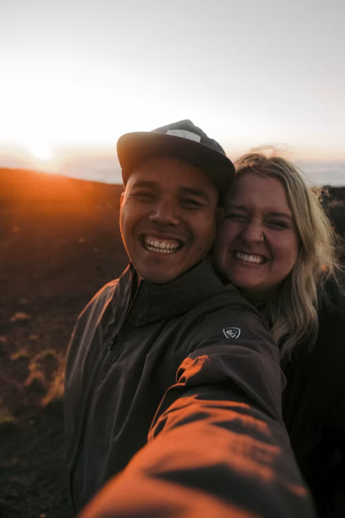 Real couple enjoying on the beach at golden sunset after matching on ZoApp